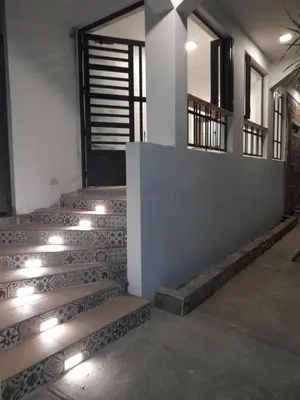 a set of stairs in a building with lights at Hostal Marina Samana in Santa Bárbara de Samaná