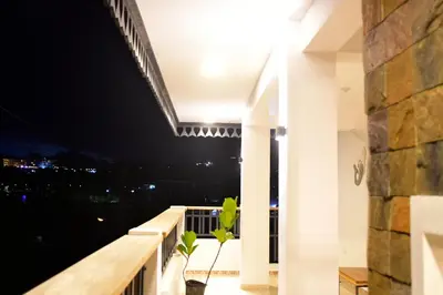 a view from the balcony of a house at night at Hostal Marina Samana in Santa Bárbara de Samaná