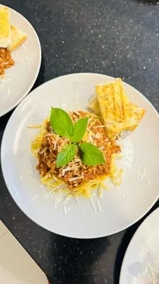 a plate of pasta with a green leaf on top at Villa Brise de Mer in Las Terrenas