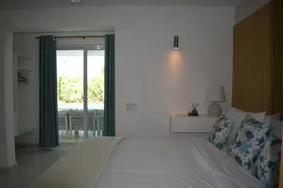 a bedroom with a bed and a sliding glass door at Villa Brise de Mer in Las Terrenas