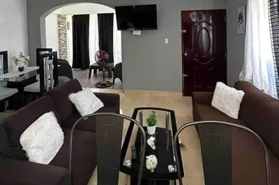 a living room with a couch and a table at Casa Linda - 10 mins from Beach & Lagoon with AC & Free Parking in Payita