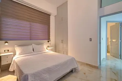 a bedroom with a white bed and a window at spectacular sea view in Santo Domingo