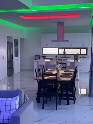 a dining room with a wooden table and chairs at Villa Ocean Blue in Las Terrenas