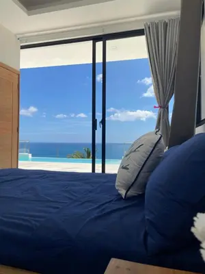 a bedroom with a bed with a view of the ocean at Villa Ocean Blue in Las Terrenas