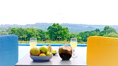 a table with a bowl of fruit and glasses of wine at Finca Jasmat in Cabrera