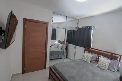 a bedroom with a bed and a large mirror at Villa Golden Dream in San Felipe de Puerto Plata