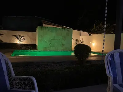 a swimming pool at night with green lighting at Villa Golden Dream in San Felipe de Puerto Plata