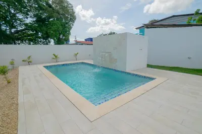 a swimming pool in the backyard of a house at Villa Golden Dream in San Felipe de Puerto Plata