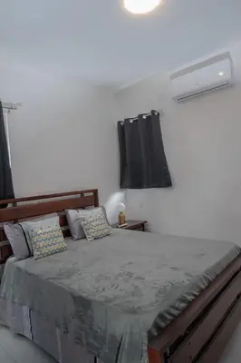a bedroom with a large bed with avertisementatronatronstrationstrationstration at Villa Golden Dream in San Felipe de Puerto Plata
