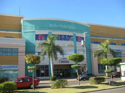 a building with a car parked in front of it at Modern and centric Apartment with pool and gym at Downtown in Santo Domingo