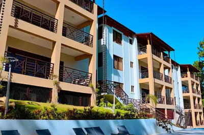 a building with balconies on the side of it at Vista del Campo Country Club & Villas in Jarabacoa