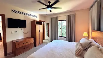 a bedroom with a bed and a ceiling fan at Vista del Campo Country Club & Villas in Jarabacoa