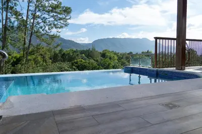 a swimming pool with a view of the mountains at Vista del Campo Country Club & Villas in Jarabacoa