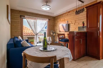 a living room with a table and a blue couch at Loft con terraza en Santo Domingo in La Estrella