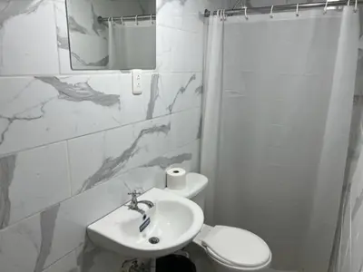 a bathroom with a sink and a toilet at Hostal 53 Boutique Santo Domingo in Santo Domingo