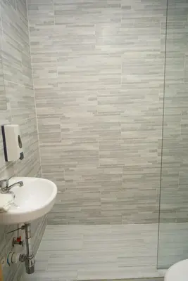 a bathroom with a sink and a shower at Hostal 53 Boutique Santo Domingo in Santo Domingo