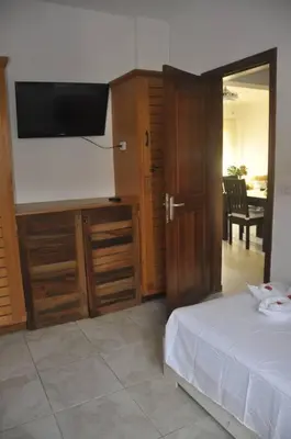 a bedroom with a bed and a flat screen tv at Apartamento con vista a la piscina in Las Terrenas