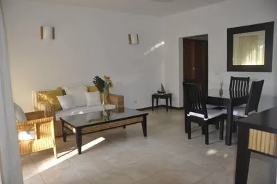a living room with a couch and a table and chairs at Apartamento con vista a la piscina in Las Terrenas