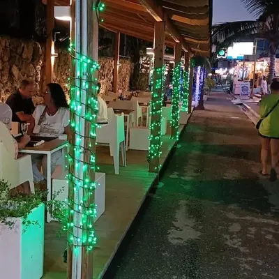 a restaurant with green lights on a pole at El Rinconcito Caribeño in La Laguna