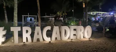 a large sign in the sand at a beach at night at El Rinconcito Caribeño in La Laguna