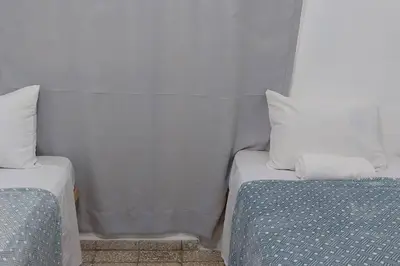 two beds sitting next to each other in a room at Beautiful sea front apartment in Paraíso