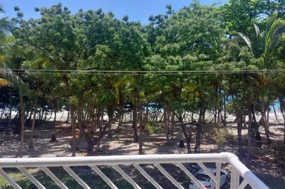 a view from the balcony of a resort with trees at Beautiful sea front apartment in Paraíso