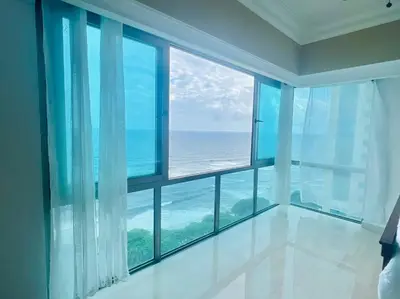 a room with a large window with a view of the ocean at Beach Front Penthouse in Exclusive Tower in Santo Domingo