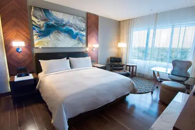 a hotel room with a large bed and a desk at JW Marriott Hotel Santo Domingo in Santo Domingo