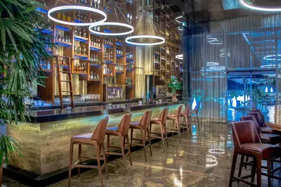 a bar in a restaurant with a bunch of chairs at JW Marriott Hotel Santo Domingo in Santo Domingo