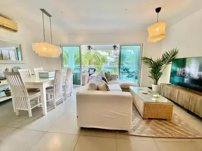 a living room with a white couch and a table at Stunning Beachfront Condo With Private Beach, Las Terrenas-El Limón in El Limón