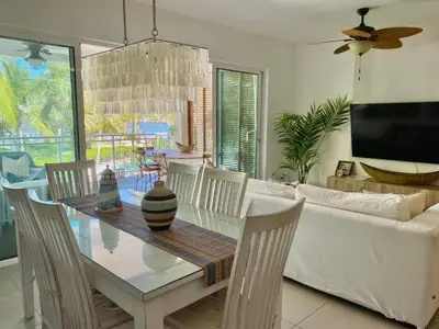 a dining room with a table and a couch at Stunning Beachfront Condo With Private Beach, Las Terrenas-El Limón in El Limón