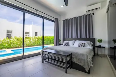 a bedroom with a bed and a large window at Sosua Ocean Village, Villa 9 Campo Del Mar , IV in Sosúa