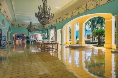 a large lobby with a chandelier and a table at Iberostar Selection Hacienda Dominicus - All Inclusive in Bayahibe