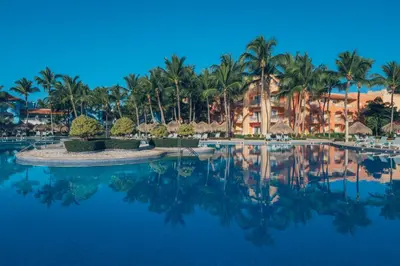 a pool at a resort with palm trees at Iberostar Selection Hacienda Dominicus - All Inclusive in Bayahibe