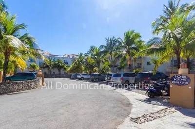 a parking lot in front of a building with palm trees at Ocean Dream Studios, kiters paradise! in Cabarete