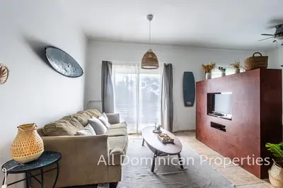 a living room with a couch and a tv at Ocean Dream Studios, kiters paradise! in Cabarete