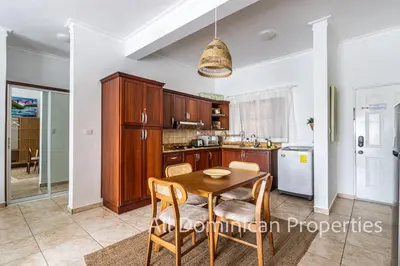 a kitchen with a table and chairs in a room at Ocean Dream Studios, kiters paradise! in Cabarete