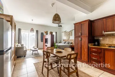 a kitchen and living room with a table and a refrigerator at Ocean Dream Studios, kiters paradise! in Cabarete