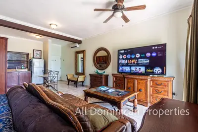 a living room with a couch and a flat screen tv at Ocean Dream Studios, kiters paradise! in Cabarete