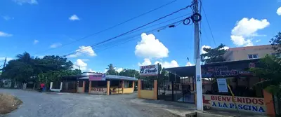 an empty street in a small town with buildings at HOTEL RANCHO EL NOVATO in Concepción de La Vega