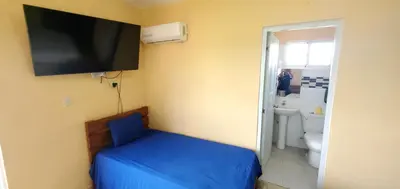a room with a bed and a tv on the wall at HOTEL RANCHO EL NOVATO in Concepción de La Vega