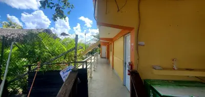 a hallway of a yellow building with a balcony at HOTEL RANCHO EL NOVATO in Concepción de La Vega