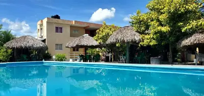 a swimming pool in front of a resort at HOTEL RANCHO EL NOVATO in Concepción de La Vega