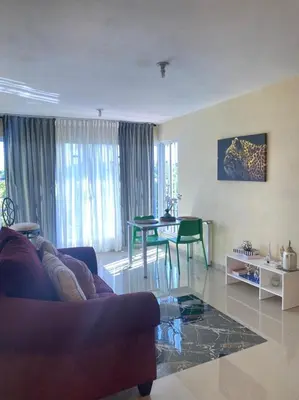 a living room with a couch and a table at Tiny Apartment By Merengue House ,8 minutos airport in Santo Domingo