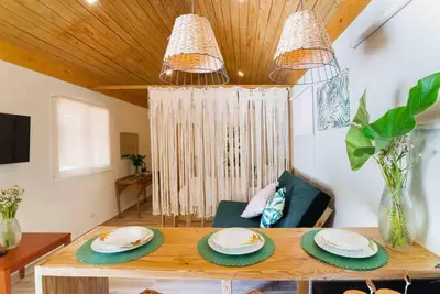 a living room with a table with plates on it at Hacienda La Huerta, Puerto Plata in San Felipe de Puerto Plata