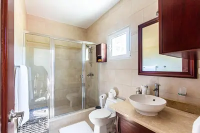 a bathroom with a shower and a toilet and a sink at Paradise Condos, Cabarete! in Cabarete