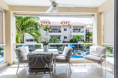 a dining room with a view of a building at Paradise Condos, Cabarete! in Cabarete