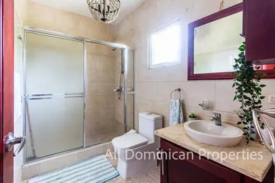a bathroom with a shower and a toilet and a sink at Paradise Condos, Cabarete! in Cabarete