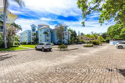 a car parked in a parking lot in front of some buildings at Victorian Condominium, Cabarete! in Cabarete