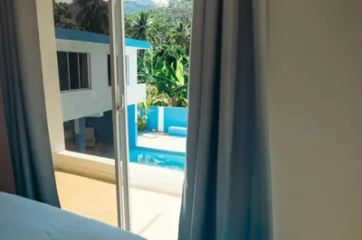 a room with a window with a view of a pool at Parador El Ermitaño in Santa Bárbara de Samaná